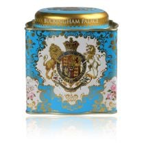 Buckingham Palace Coat of Arms Royal Tea caddy featuring a lion and unicorn royal crest surrounded by ornated gold patterns and english rose patterns on a turquoise blue coloured background. The lid has the words Buckingham Palace, Windsor Castle and Pala