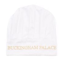 White chefs hat with Buckingham Palace embroidered in gold.