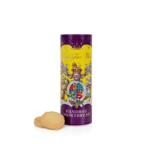 Miniature shortbread biscuit tube featuring a yellow and purple design. At the centre of the design is the coat of arms including a lion and unicorn. Next to the tube of biscuits are two shortbread rounds