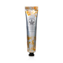 Silver tube decorated with orange design of the ingredients and a silver crown in the middle of the tube