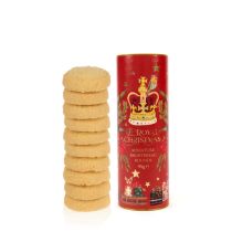 red tube packaging with illustrations of a crown, bird and presents next to the stack of miniture biscuits inside