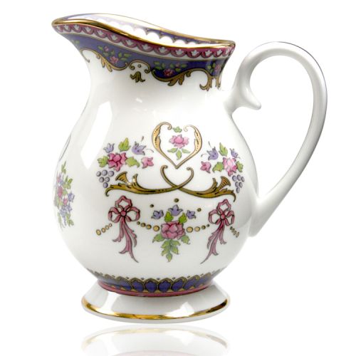 Queen Victoria fine bone china cream jug with a design featuring Queen Victoria's name cipher surrounded by floral patterns and gold plated rims.