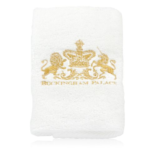 White face cloth with gold embroidery of Buckingham Palace and the Royal Coat of Arms. 