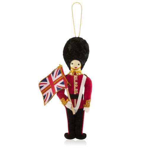 A Guardsman decoration holding a Union Jack flag. Gold string to hang. 