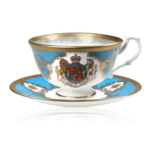 Royal coat of arms fine bone china teacup and saucer featuring a gold rims and a lion and unicorn royal crest surrounded by ornated gold patterns and English flower patterns on a turquoise blue background. 