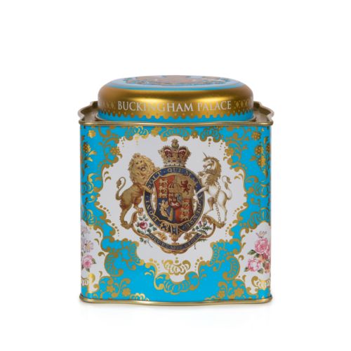 Shot of a blue and gold cube tea caddy featuring the Royal Coat of Arms including a lion and unicorn. 