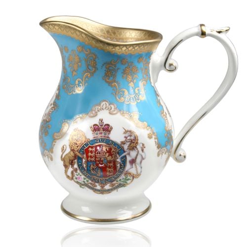 Royal coat of arms fine bone china cream jug featuring a lion and unicorn royal crest surrounded by ornated gold patterns and English flower patterns on a blue coloured background. 