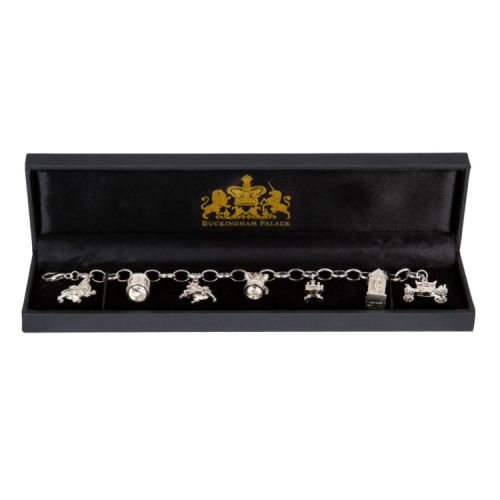 19 cm sterling silver charm bracelet with 7 different charms symbolising the British Monarchy including a throne charm, Guardsman charm, carriage charm, Windsor Castle tower charm, crown charm, lion charm and unicorn charm. 