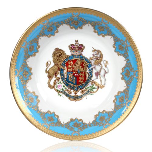 Royal coat of arms fine bone china footed bowl featuring a lion and unicorn royal crest surrounded by ornated gold patterns and English flower patterns on a blue coloured background. Gilded and decorated on the inner and outer side. 