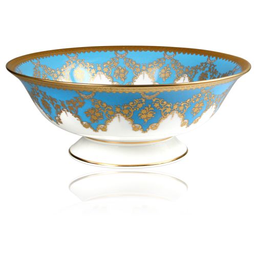 Royal coat of arms fine bone china footed bowl featuring a lion and unicorn royal crest surrounded by ornated gold patterns and English flower patterns on a blue coloured background. Gilded and decorated on the inner and outer side. 