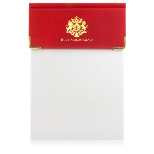 Red leather desk pad, with sheets of white note paper. With gold crest and the words 'Buckingham Palace' on the red leather