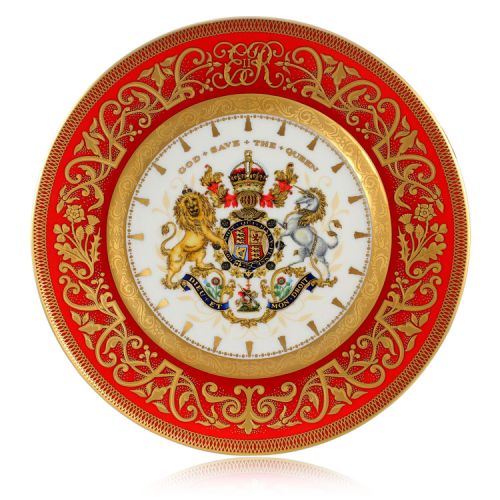 The official commemorative Coronation English fine bone china side plate with a design featuring a royal coat of arms cicled by gold ornamental features on a red background border. 