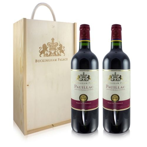 Wooden wine box stamped with gold Buckingham Palace and motif. Two bottles of Pauillac pictured next to it. White labels with maroon accents on label and neck. 