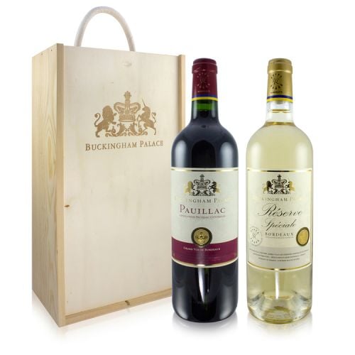 Wooden wine box stamped with gold Buckingham Palace motif. Two bottles of wine pictured next to it, one red and one white with white and gold labels. 