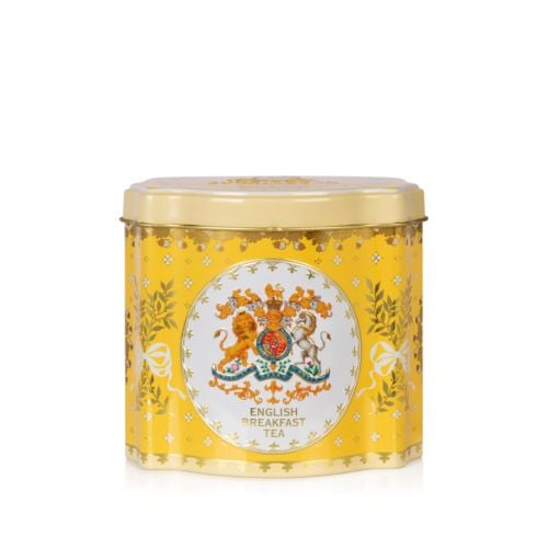 Tin tea caddy is yellow and decorated with the Royal Coat of Arms, leaves tied with bows and acorns.  