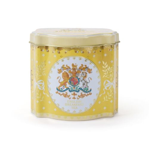 Tin tea caddy is yellow and decorated with the Royal Coat of Arms, leaves tied with bows and acorns.  