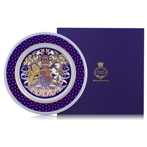 A dinner plate with the lion and unicorn crest at the centre of the plate. Surrounding the crest is a purple, gold and light blue design