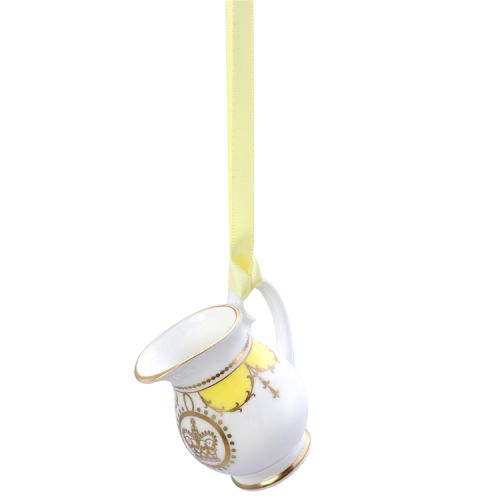 Miniature yellow tankard with gold crown detail. It is  hanging from a yellow ribbon