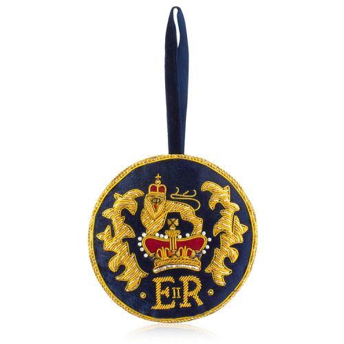 Round navy velvet decoration with gold threads and design. The design includes a lion above a red crown.