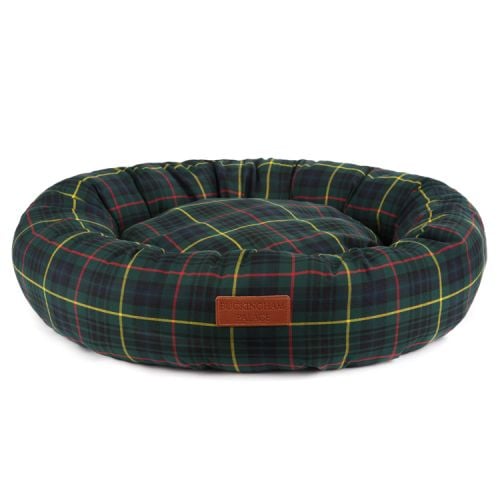 Tartan circular dog bed with a brown leather tag sewn to the front engraved with the words 'Buckingham Palace'