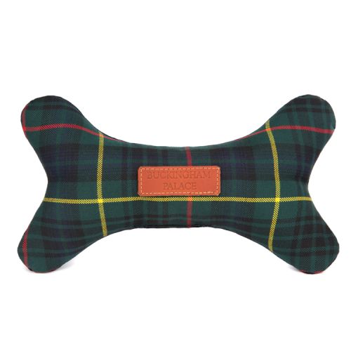 green tartan dog toy in the shape of a bone. A leather tag printed with 'Buckingham Palace' is stitched on