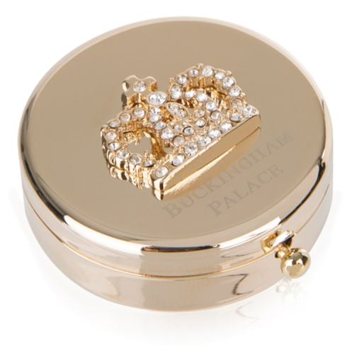 Gold compact mirror with bejewelled crown on top. Buckingham Palace etched below.