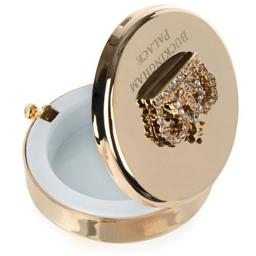 Gold compact mirror with bejewelled crown on top. Buckingham Palace etched below.