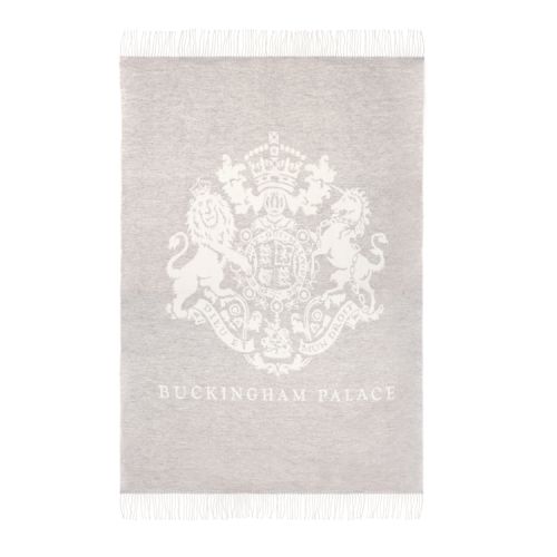 grey wool blanket with a white crest and the words 'Buckingham Palace' on the front