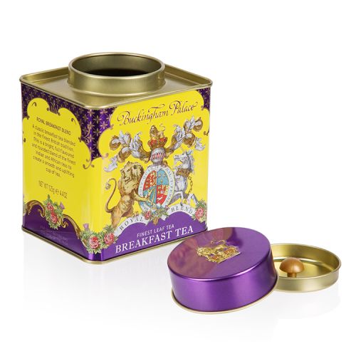 yellow and purple breakfast tea tin displaying the crest of arms with the lid off and next to the tin