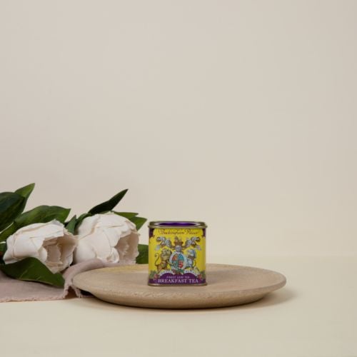 Small tin Breakfast Tea tea caddy with a purple and yellow design and a lion and unicorn crest at the centre of the design