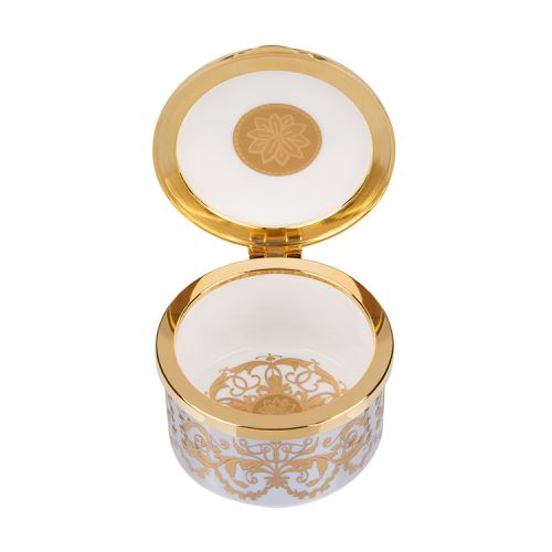 Blue,  white and gold pillbox. The edge of the pillbox is blue with swirly gold design. The lid is white with the gold lion and unicorn crest