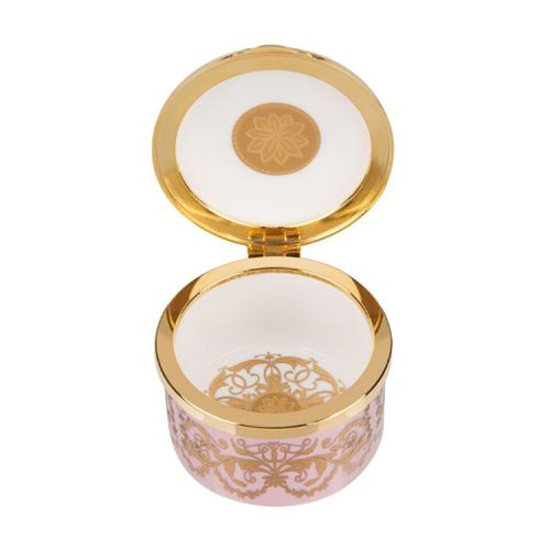 Pink, white and gold pillbox. The edge of the pillbox is pink with swirly gold design. The lid is white with the gold lion and unicorn crest