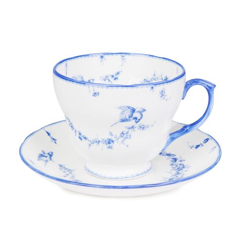 White teacup and saucer with a blue floral garland and  bird design