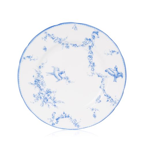 A white side plate with blue floral garland and bird design.