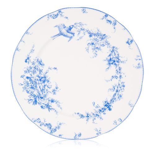 A white dinner plate with a blue floral garland and bird design