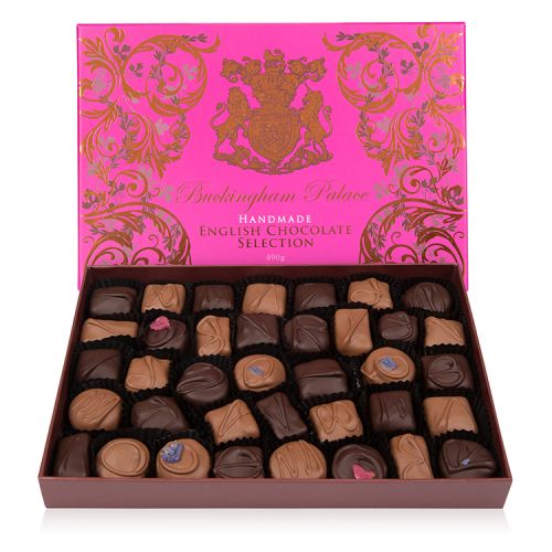 open box of chocolate selection in a pink box with gold swirl