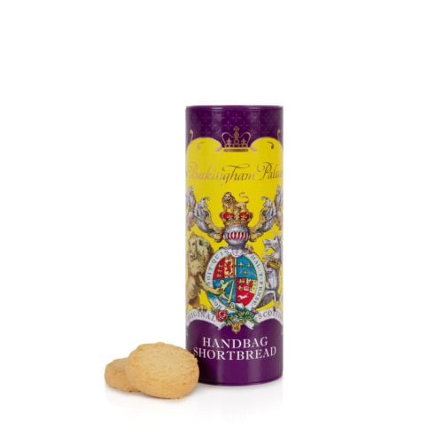 Miniature shortbread biscuit tube featuring a yellow and purple design. At the centre of the design is the coat of arms including a lion and unicorn. Next to the tube of biscuits are two shortbread rounds