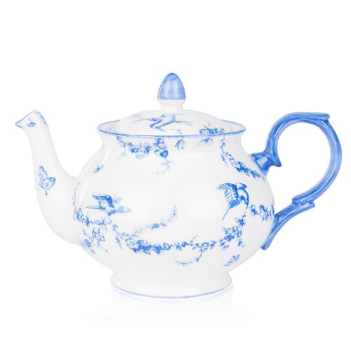 A white teapot with blue floral garland and bird design.