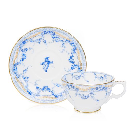 a white teacup and saucer decorated with a blue floral garland and bird design. Finished with 22 carat gold rim