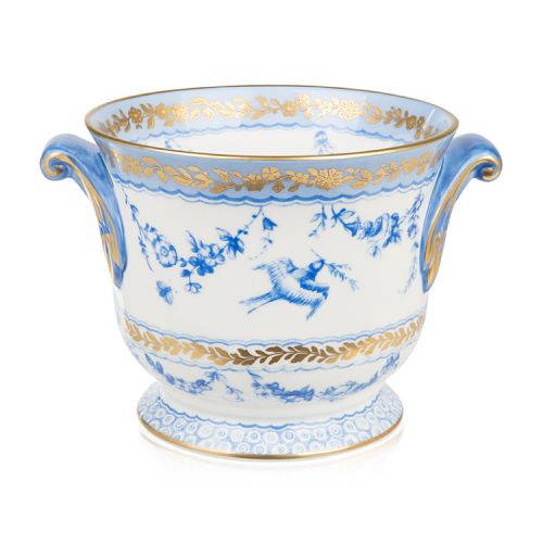 White cache pot with a blue floral garland and bird design and finished with gold detail and gold edge of the cache pot