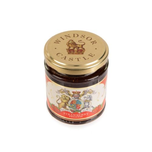 glass jar of strawberry jam with a gold lid. The label is red and white with the unicorn and lion crest