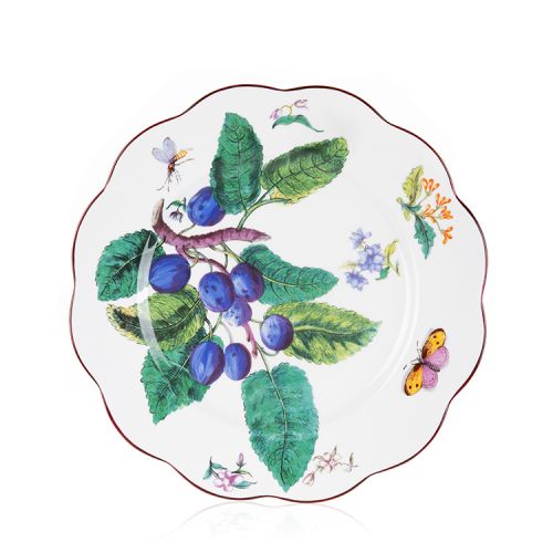 A scalloped plate with the Chelsea porcelain design. The design includes berries, leaves and butterflies