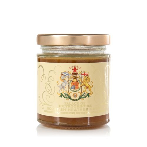 Glass jar of honey with gold lid. The jar is wrapped with a label displaying the Scottish Coat of Arms