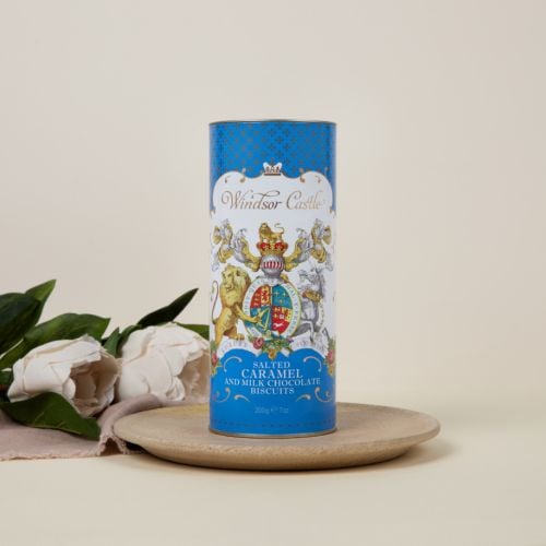 blue cardboard tube of salted caramel and milk chocolate biscuits with crest at the centre