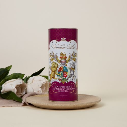 Purple cardboard tube of raspberry and white chocolate biscuits. The lion and unicorn crest is at the centre of the design underneath the words 'Windsor Castle.' Next to the tube feature two biscuits