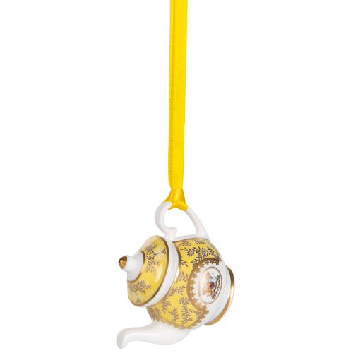 Miniature yellow teapot with gold crown detail. It is  hanging from a yellow ribbon