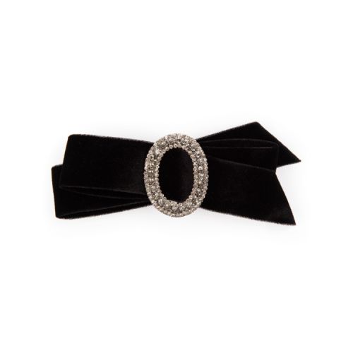 Black velvet bow with silver and crystal encrusted oval at the centre. 