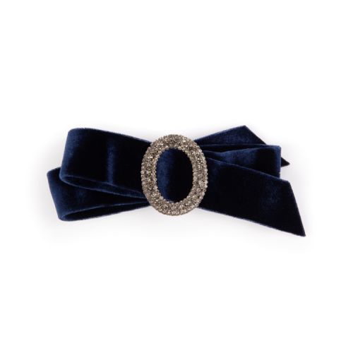 Navy velvet bow with silver and crystal encrusted oval at the centre.
