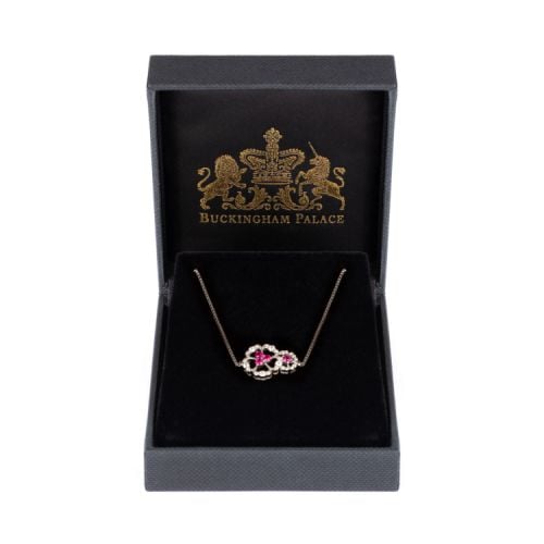 Silver bracelet with two floral details with a pink crystal centre