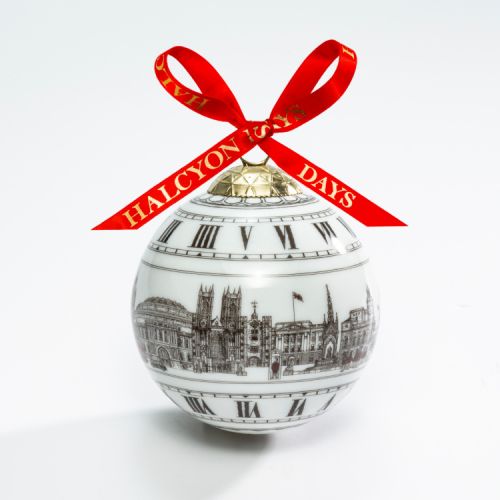 Christmas bauble depicting monument and landmarks in London including Royal Albert Hall, Westminster Abbey and Buckingham Palace. All illustrations are in black and white and the bauble is complete with a red bow